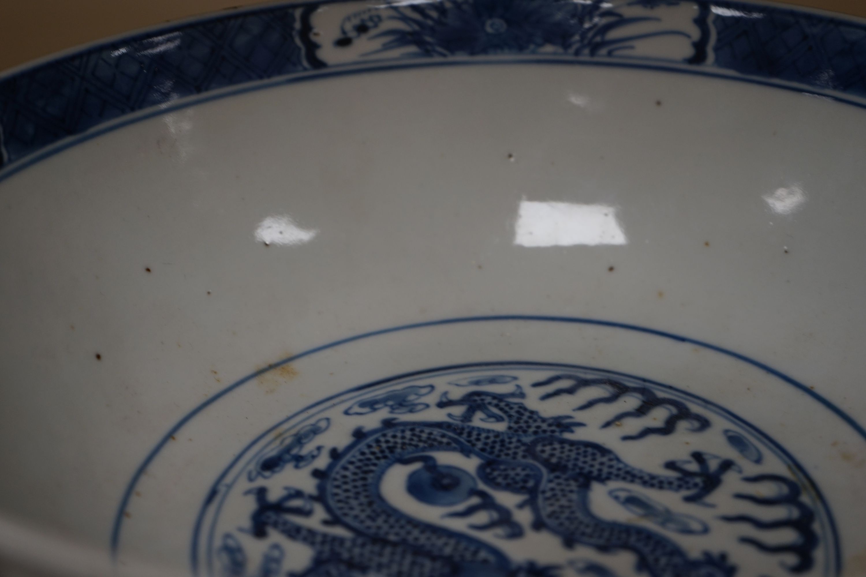 A Chinese blue and white ‘dragon’ bowl, Kangxi mark, late 19th century 25cm